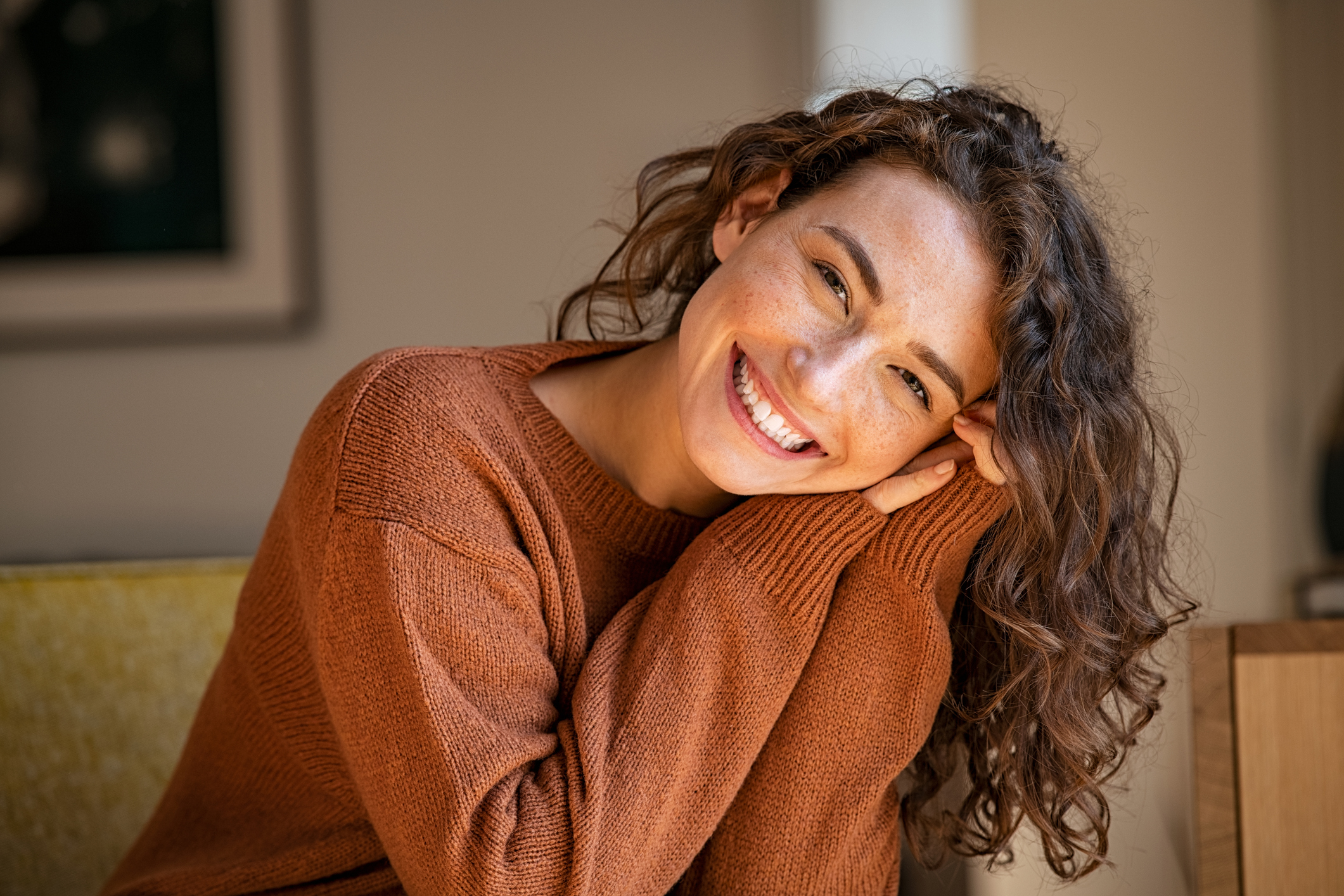 Happy woman relaxing in a cozy home setting