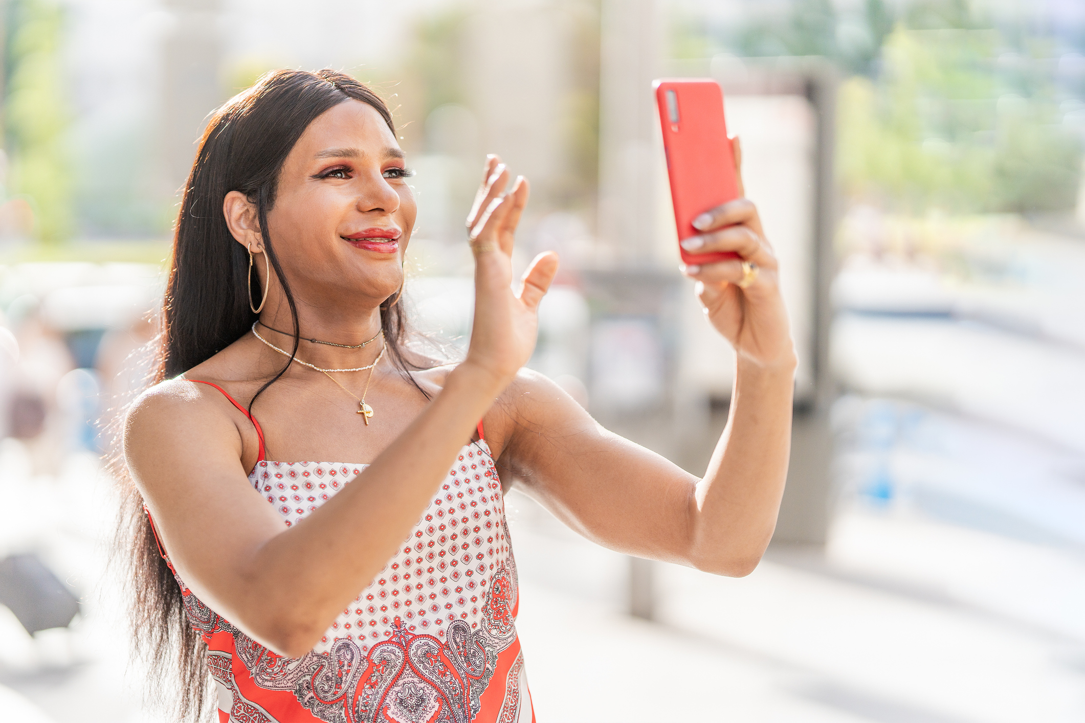 Trans woman waving during a video call