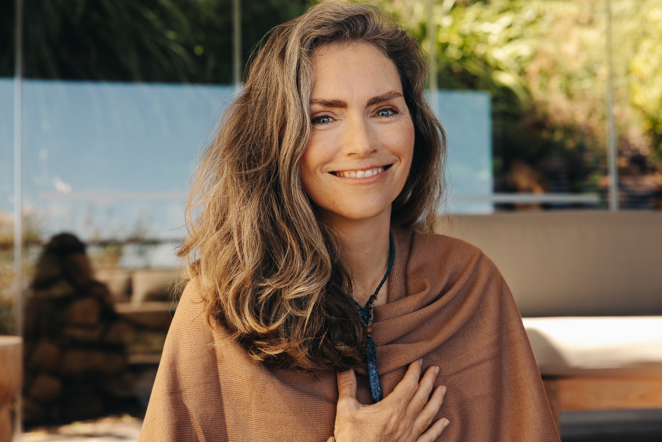 Woman practicing crystal healing and meditation, embracing holistic wellness