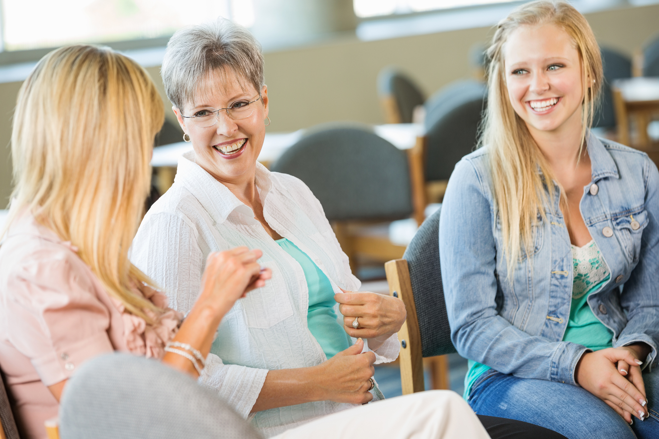 Diverse group of women in thoughtful, supportive conversation